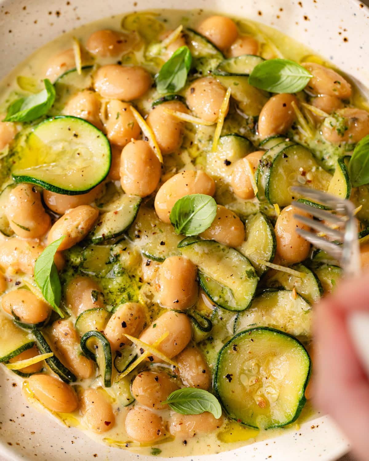Assiette de courgettes mijotées et haricots blancs crémeux au pesto