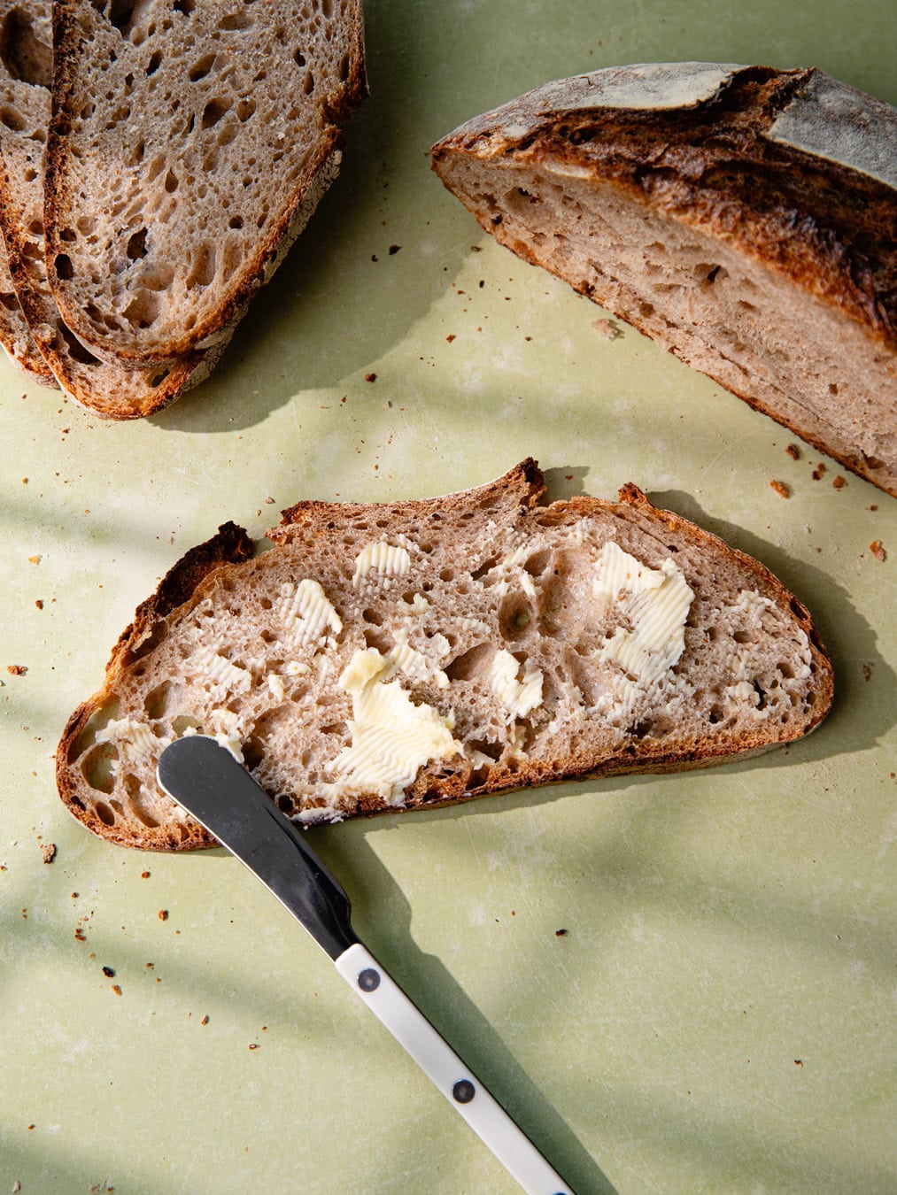 Tranche de pain de campagne au levain beurrée